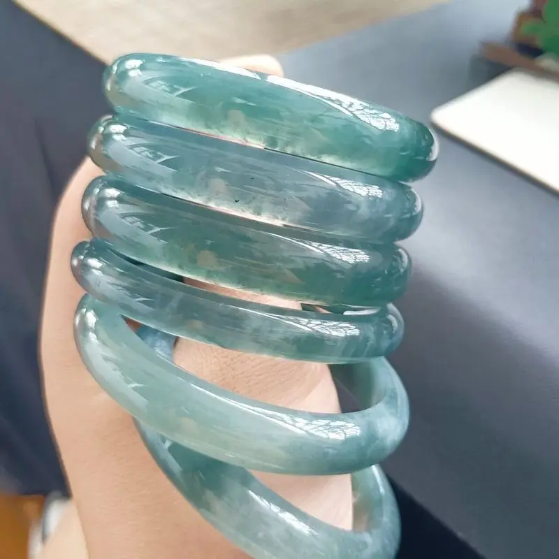 Fine jadeite bracelet, smooth and translucent, with a blue sheen, regular circular shape