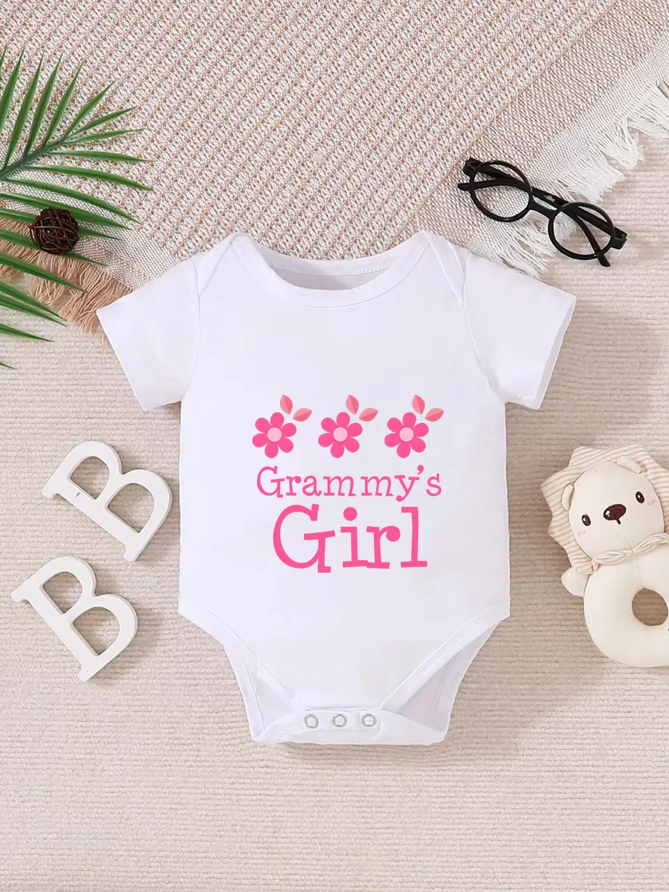 Playful letter-printed baby short-sleeve triangle bodysuit. Button closure for easy dressing, machine washable