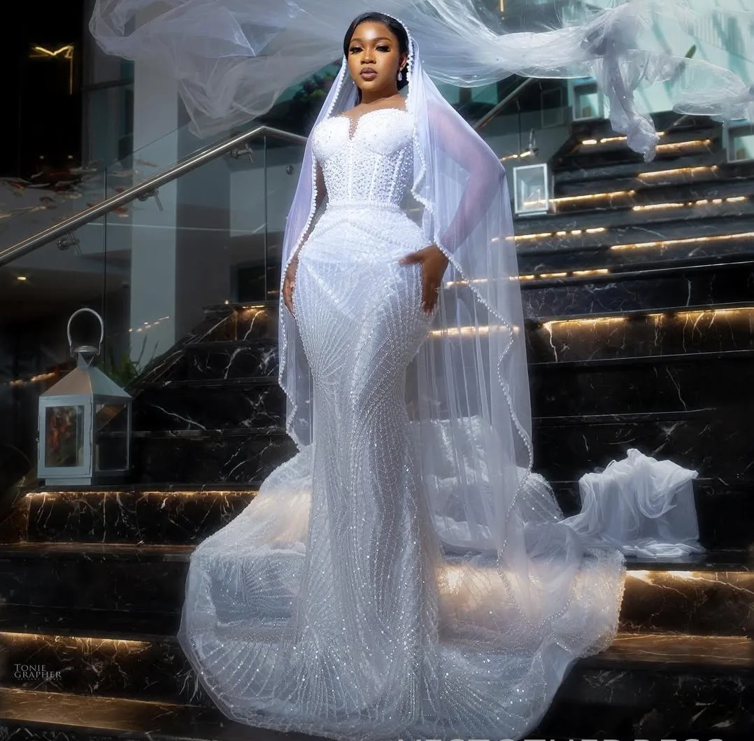 

2025 New Mermaid African Wedding Dress Illusion Beaded Lace Long Sleeves Pearls Princess Bridal Bride Gowns Vestido De Noiva