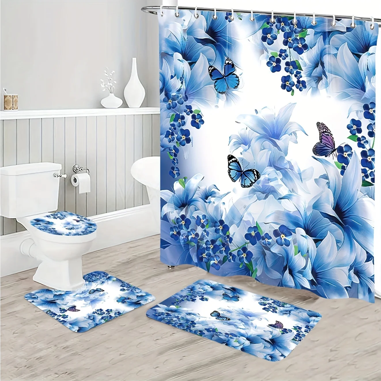 

4pc Blue iris patterned bathroom set includes a shower curtain, U-shaped floor mat, non-slip mat, and toilet seat cover.