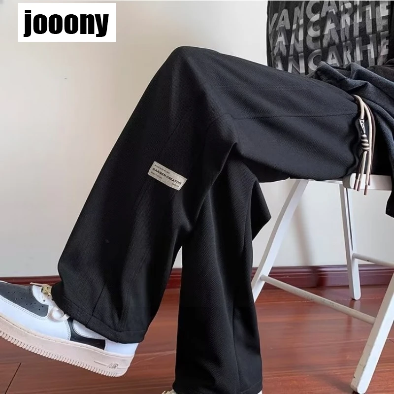 Uomo 2024 primavera autunno Hip Hop pantaloni larghi gamba dritta pantaloni sportivi etichetta laterale Design Streetwear pantaloni maschili pantaloni sportivi pantaloni sportivi