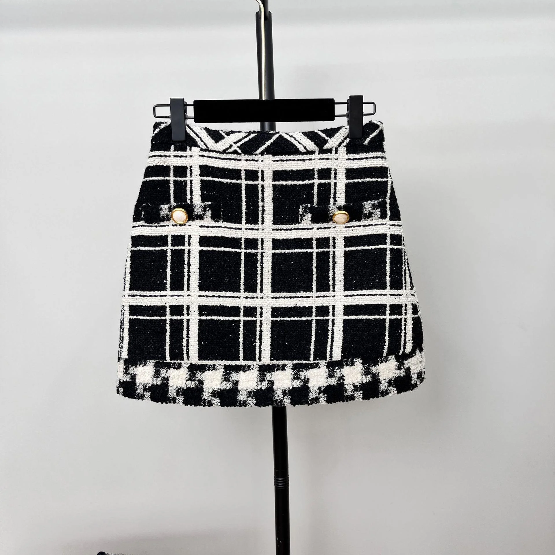 

Весна 2026: Новая модель женской юбки в красно-черную клетку с узором «птичья лапка», средней длины, с эффектом цветового сопрежения