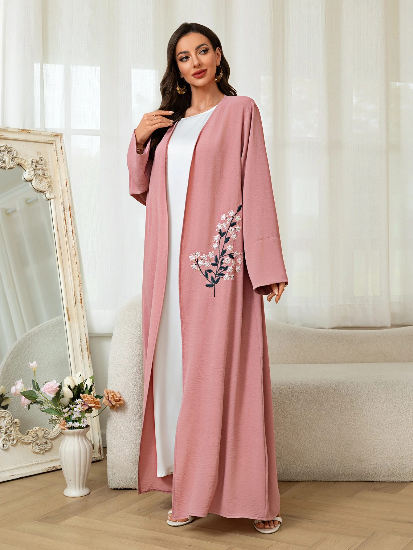 

Pink Islamic Abaya featuring floral embroidery ideal for Middle East fashion and modest style showcasing elegance and cultural