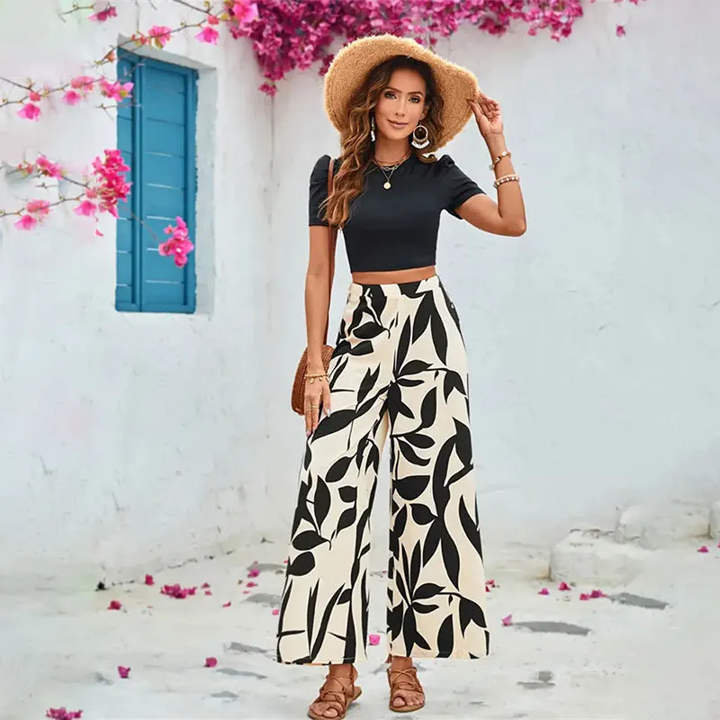 2025 Primavera/Novedad de verano, pantalones informales con estampado de hojas, pantalones de pierna ancha, conjunto de dos piezas de manga corta, camiseta abierta ajustada, trajes de mujer