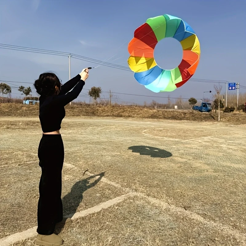 Outdoor hand pulled rolling dragon kite, adult spinning soft rainbow kite, beach park camping and flying view 2