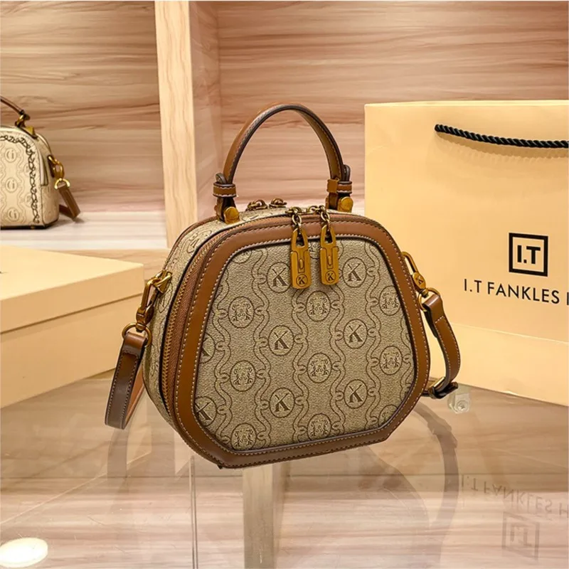 Brand handbag women's winter 2026 model simple hand-held crossbody small bag single shoulder round cake small round bag