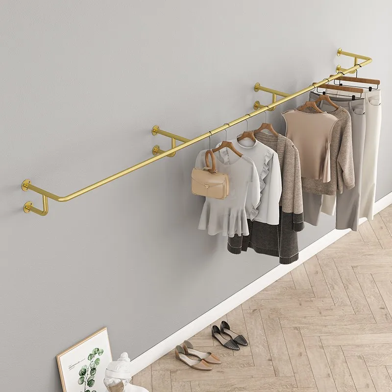 Gold clothing store is hanging on the wall, shelf, display rack, yellow titanium gold hanger, round tube, side hanger.