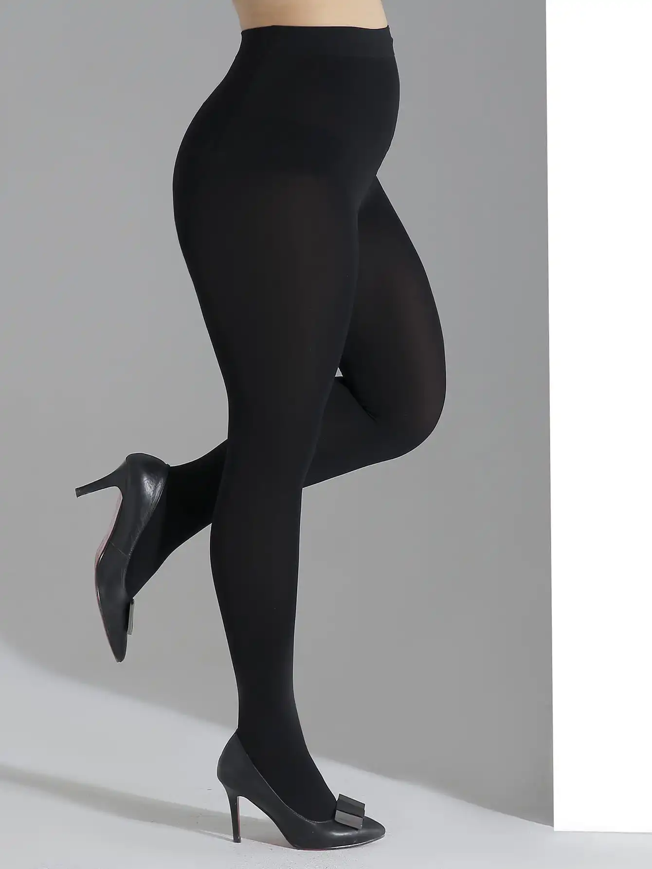 A fashionable women\'s solid black oversized pantyhose