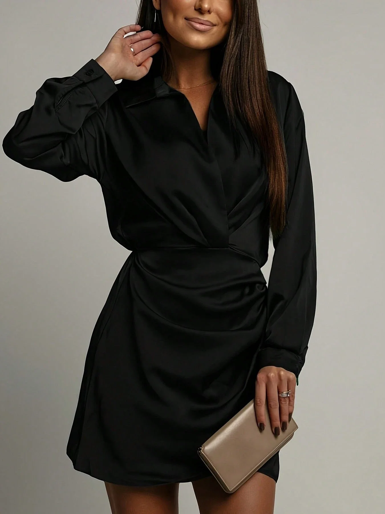 

Elegant Black Satin Mini Dress Featuring Long Sleeves, Shirt Collar, And Asymmetrical Ruched Wrap Design For Evening Styling