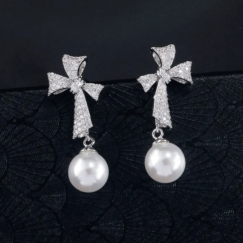 Zakol einfache neue trend ige koreanische Bogen Zirkon Perle Tropfen Ohrringe für Frauen Luxus Verlobung Hochzeit Schmuck Großhandel
