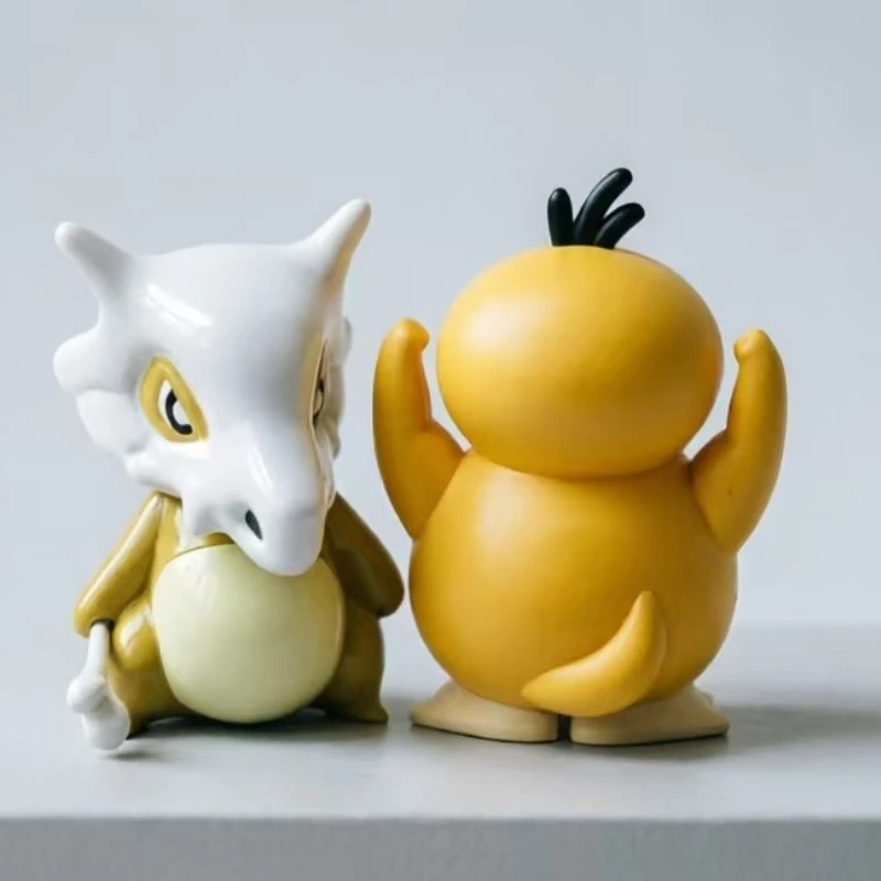 Classic  Pokemon duo: Cubone & Psyduck. Premium collectible figures for desk or car decor. Perfect for fans & collectors.