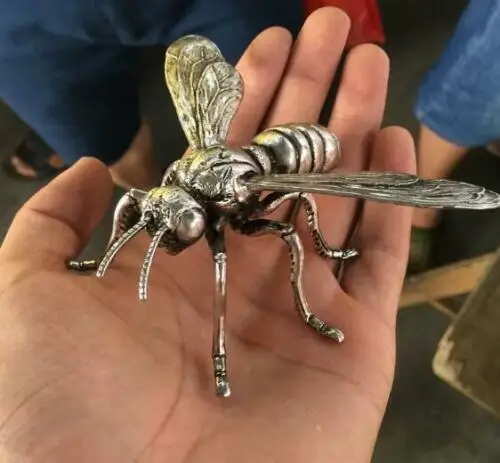 

Hand sculpture of the Miao silver statue, realistic dragonfly