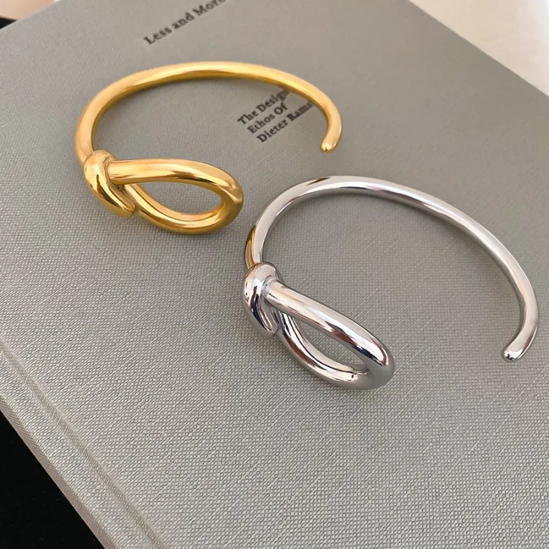 

Minar Simple Metallic Smooth Surface Hollow Out Knotted Geometric Round Opening Bangles for Women 18K Gold Silver Titanium Steel