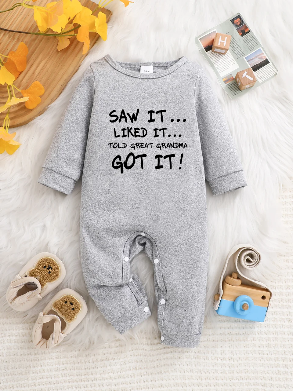 A baby long-sleeved onesie with interesting letter prints. It features a buttoned design for easy putting on and taking off