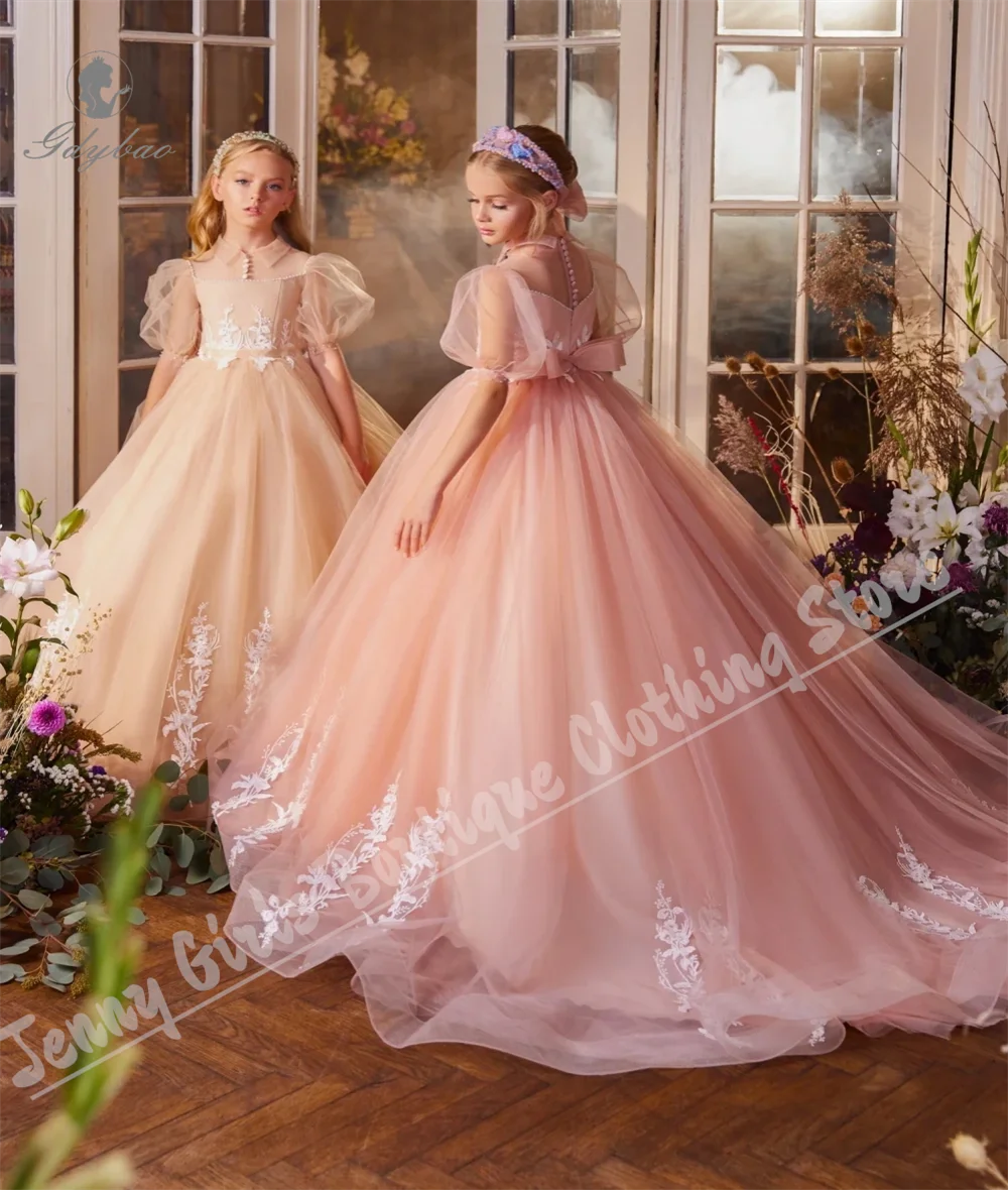 ชุดเจ้าหญิงหลอนสีชมพูที่มีเสน่ห์พร้อมแขนสั้นหวานปุยเด็กชุดวันเกิดสำหรับงานแต่งงาน