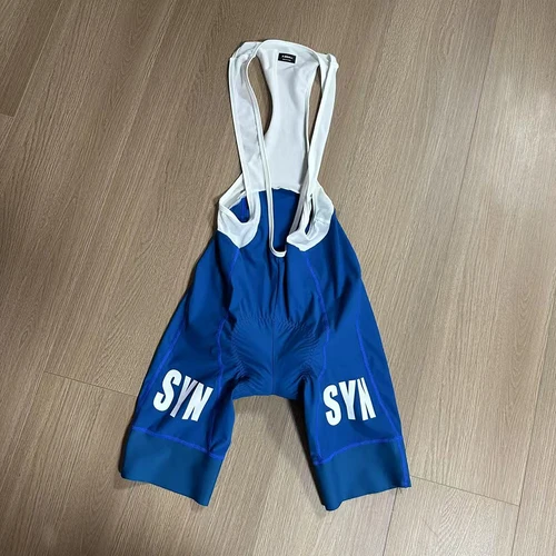 2025 SYN Configuración de alta calidad Pantalones cortos con pechera unisex Asiento de esponja a prueba de golpes Pantalones cortos MTB para mujeres y hombres