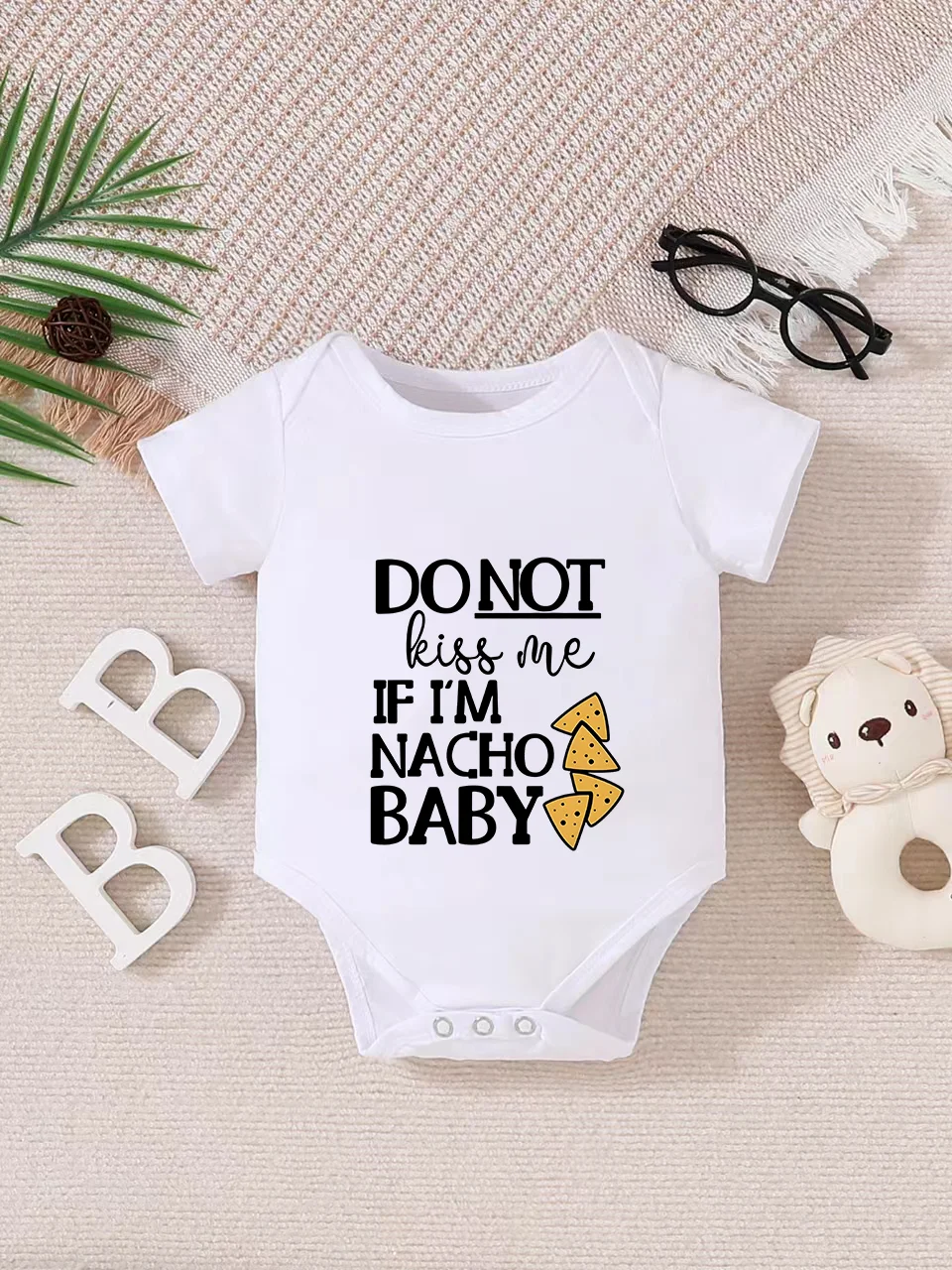 Playful letter-printed baby short-sleeve triangle bodysuit. Button closure for easy dressing, machine washable