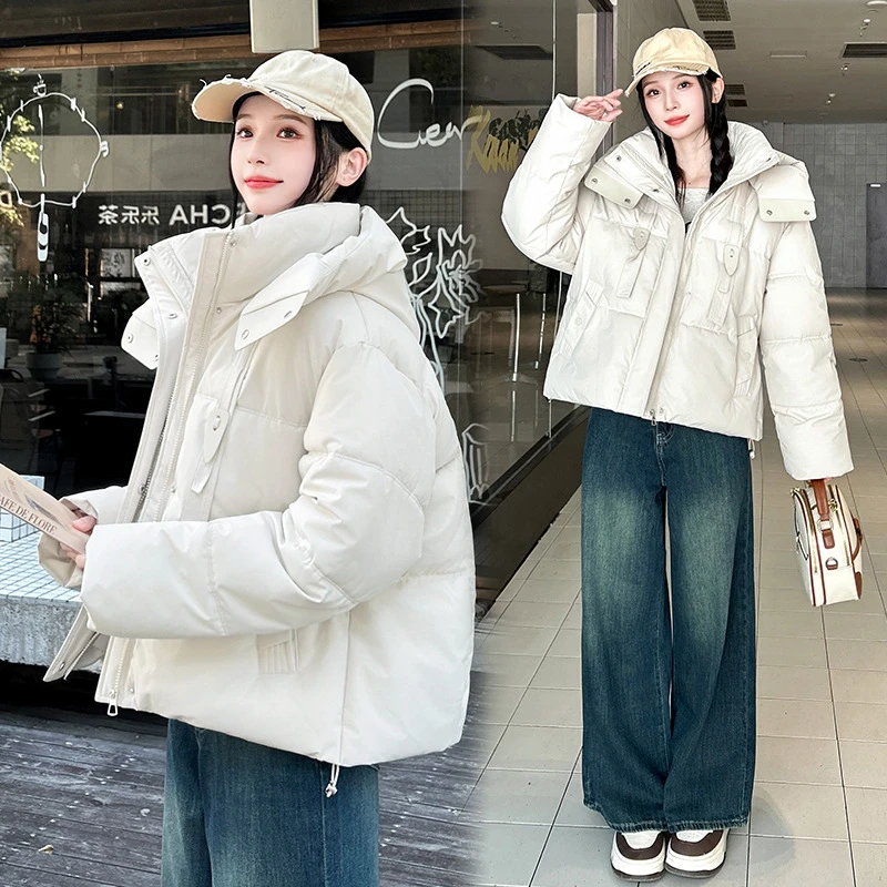 2025 Nuova giacca corta in cotone con design a nastro invernale da donna spessa Parka cappotti manica lunga tasche con cerniera con cappuccio abbigliamento casual tendenza