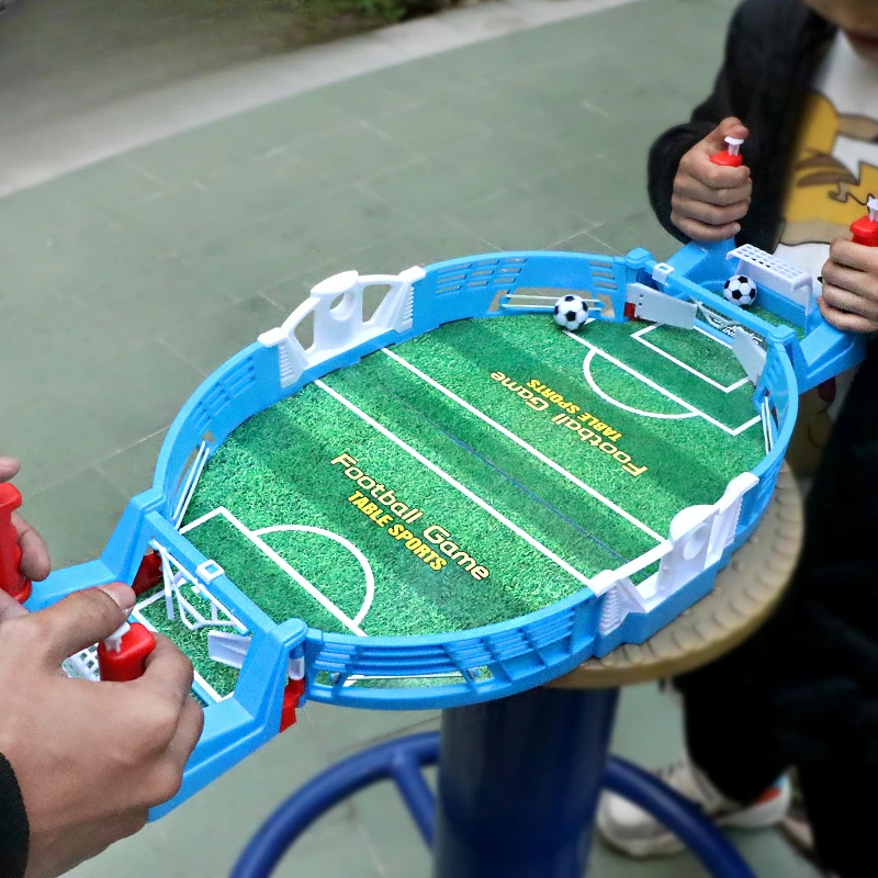 On the table, there is a soccer match between two people and a parent-child puzzle interactive New Year gift toy