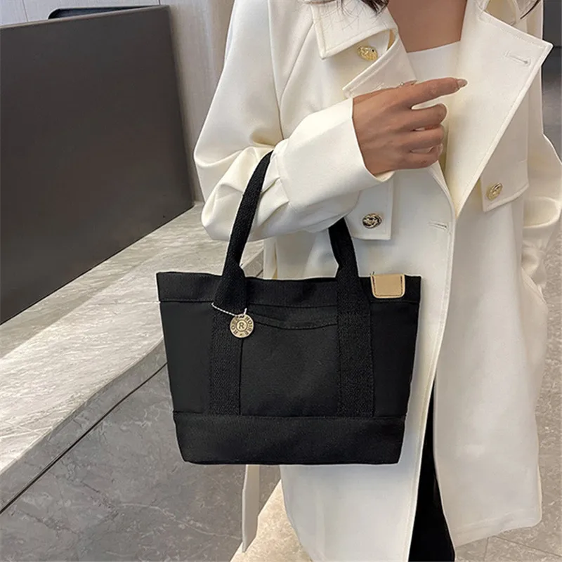 Neue einfarbige Canvas-Einkaufstasche, lässige Handtasche für Damen, Telefon, Uhr, Brille, Lippenstift, Auto, Medizin, Schlüssel usw. Tägliche Gegenstände
