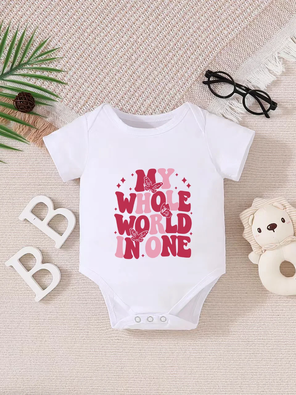 Playful letter-printed baby short-sleeve triangle bodysuit. Button closure for easy dressing, machine washable