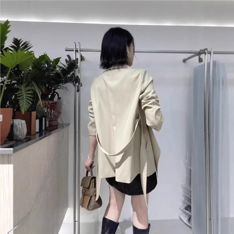 A new khaki stylish short trench coat for women with loose lapel and tie
