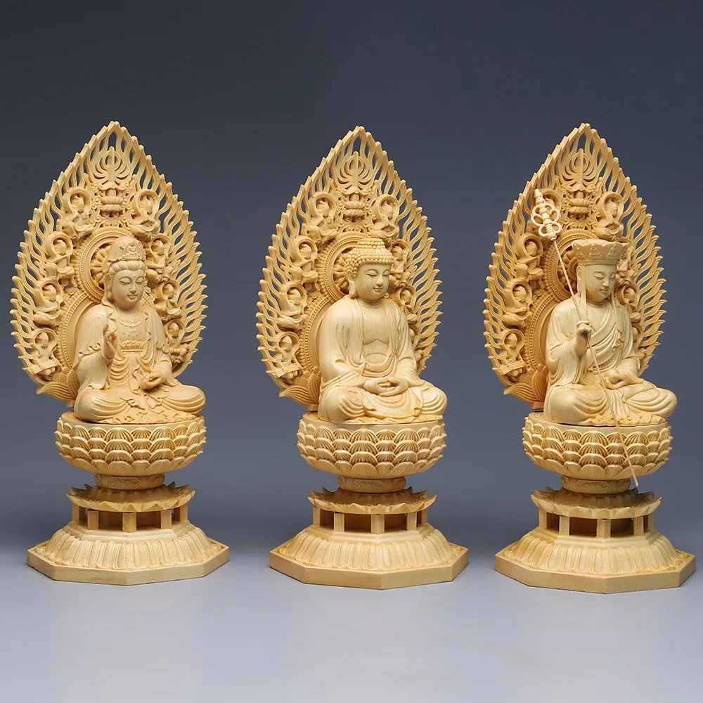 

Yellow cypress sits on the ornaments of three western Buddha statues. Tibetan Guanyin solid wood of King Sakyamuni Buddha.