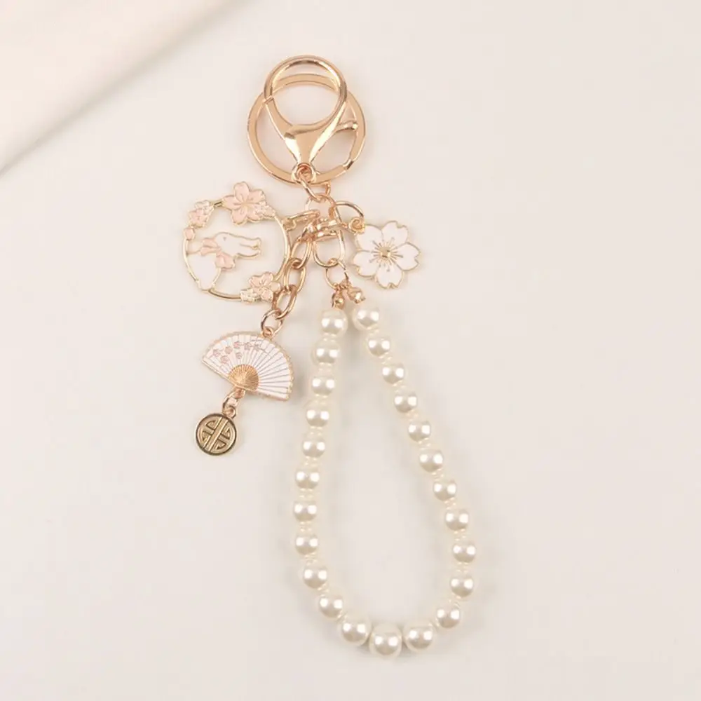 هدية حقيبة سماعة الاذن زوجين ساكورا Kawaii اللؤلؤ أرنب المفاتيح الكورية نمط قلادة الأزهار سبيكة كيرينغ المرأة على ظهره ديكور