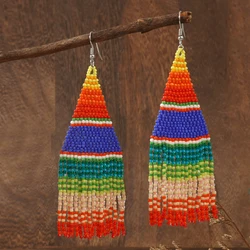 A pair of colorful striped Bohemian vacation style Su Mi bead woven earrings, hand woven earrings accessories