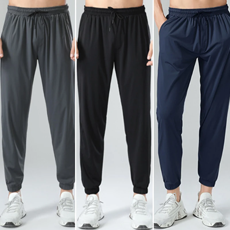 ผู้ชายวิ่งออกกําลังกายบาง Sweatpants ชายกลางแจ้งการฝึกอบรมกีฬายาวกางเกงวิ่งออกกําลังกายกางเกงเพาะกาย