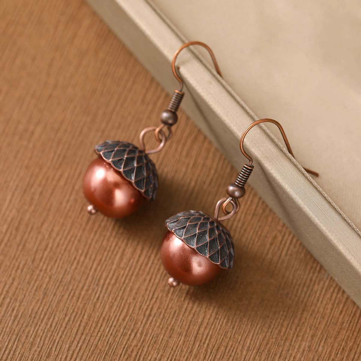 Retro-style double-color acorn-shaped pendant earrings for women, suitable for both casual and professional wear.