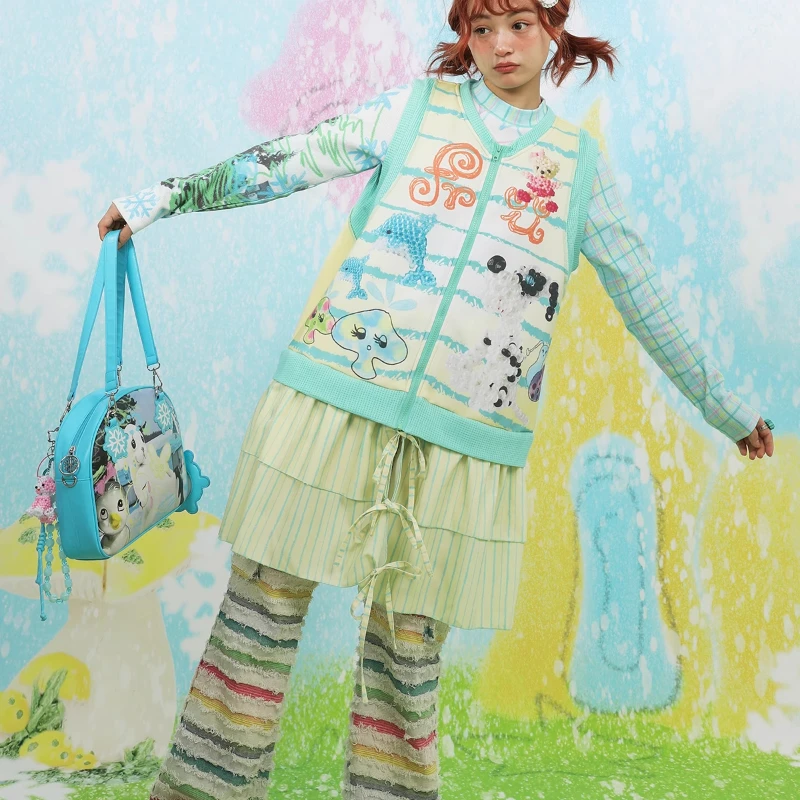 日本の女性の服春と秋のオリジナルデザインのドレス漫画の印刷スプライシングニット黄緑の弓ベストドレス