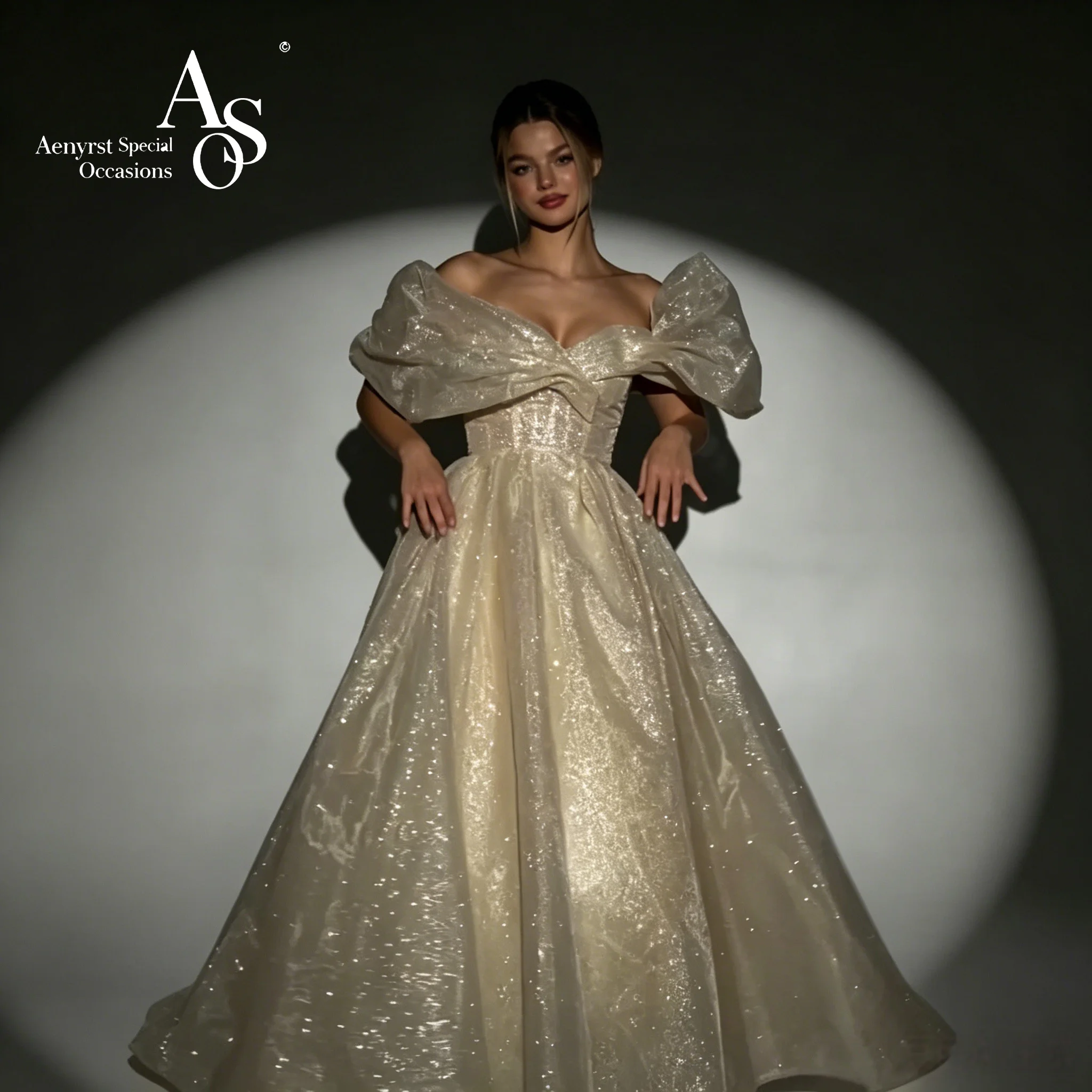 

Stunning off-the-shoulder strapless sleeveless floor-length ball gown in an elegant off-white hue featuring sparkling tulle