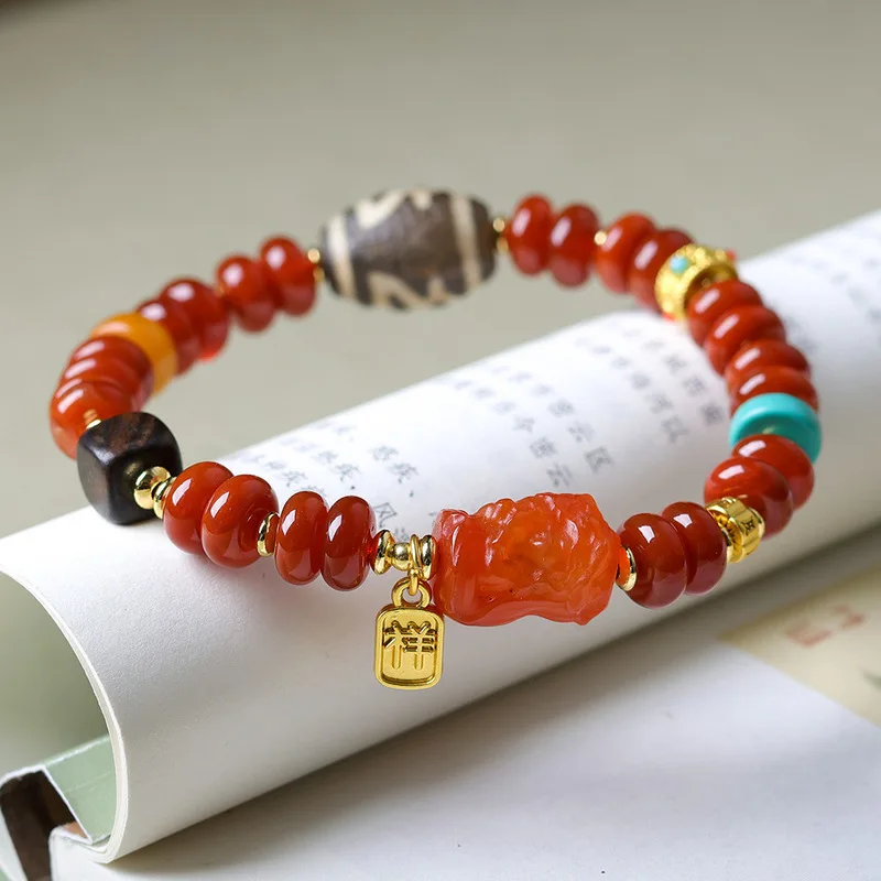 South Red Agate Abacus Bracelet a decorative piece featuring a Zaki Ram Buddha of Wealth and a Dharma Wheel bead along wi