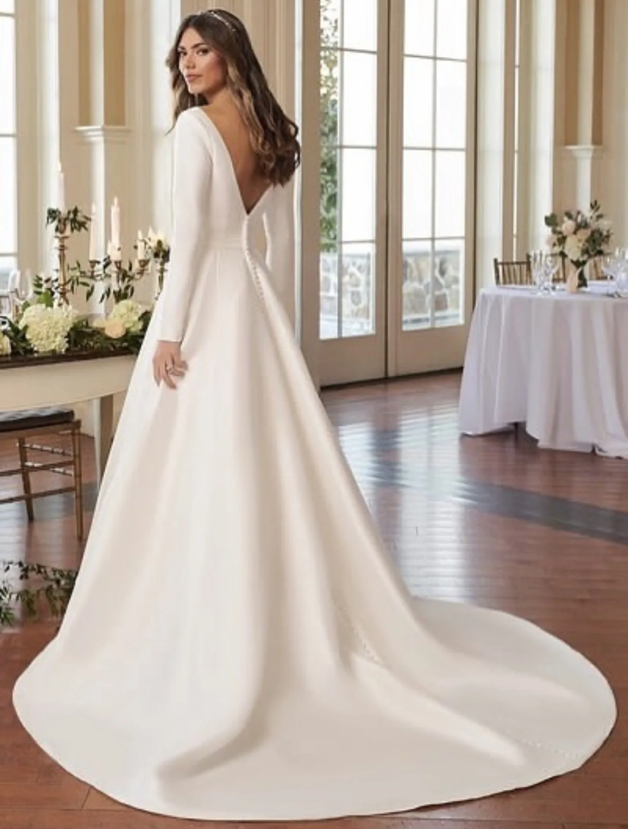 

Custom-made luxury long, shiny V-neck satin wedding dress with full sleeves sweeping the front hall of the train Novia