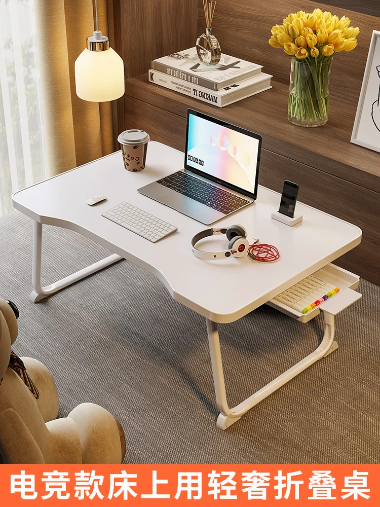 Small writing table, laptop, lazy table, student sitting on the floor, folding study desk