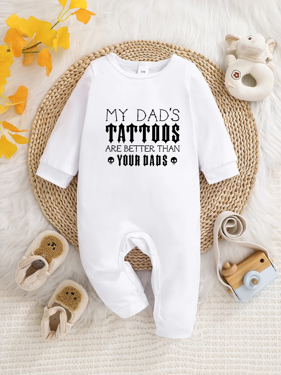 A baby long-sleeved onesie with interesting letter prints. It features a buttoned design for easy putting on and taking off, and