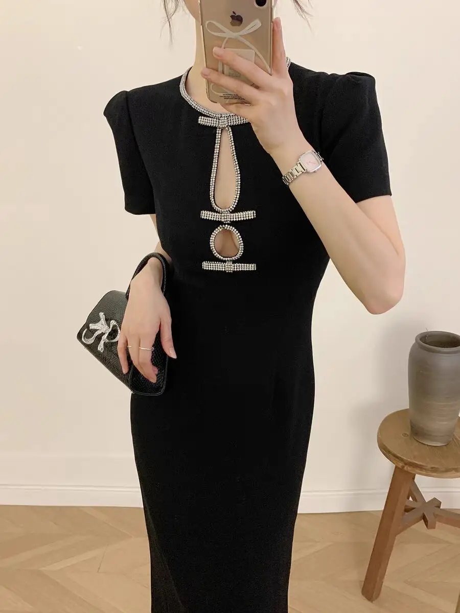 

Women's black round neck diamond embellished bow dress paired with a retro style mid length dress