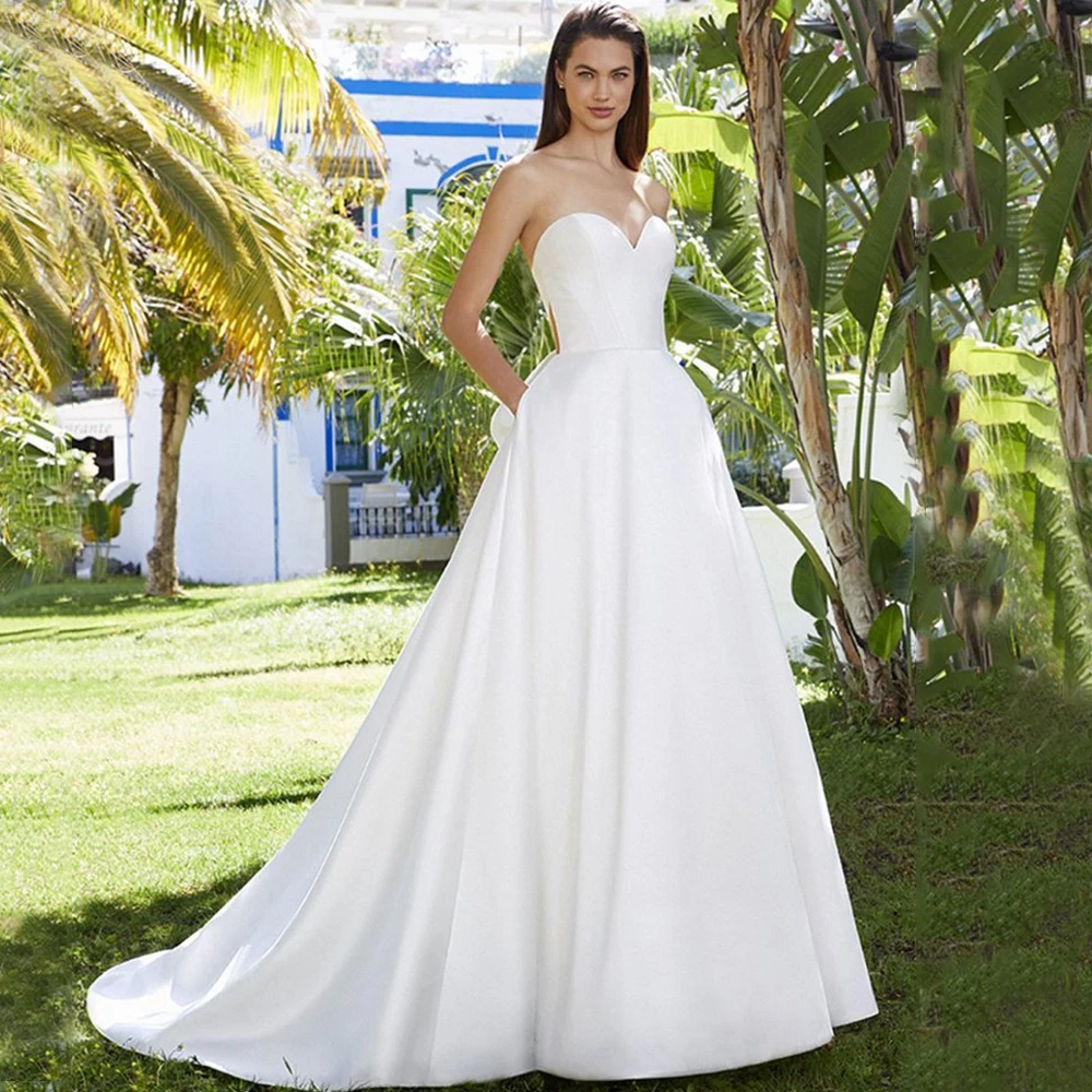 Classic Open Back Sweetheart Wedding Dress Strapless Sleeveless A-Line Floor Length with Bow and Buttons Bridal Pocket Gowns