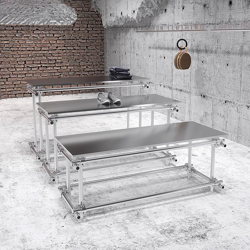 Stainless steel water table display stand in the middle of the island table in the clothing store