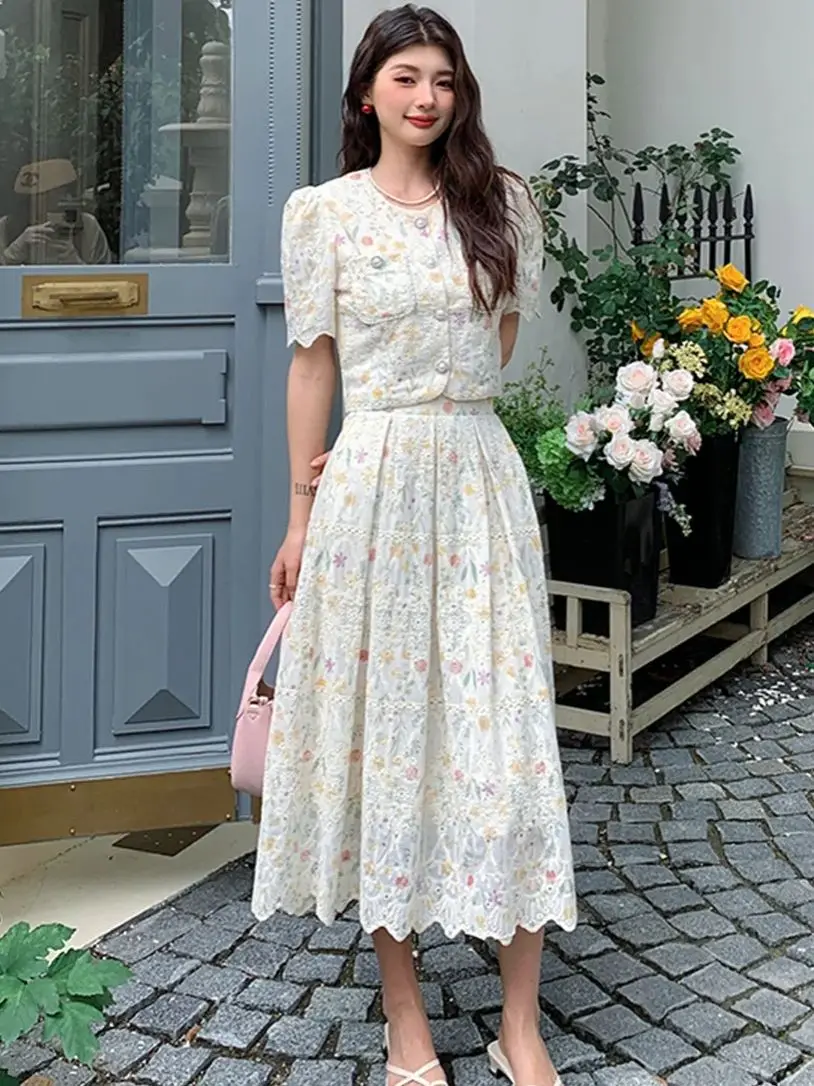 

Маленький комплект из двух предметов с ароматным ветром и цветочным принтом для женщин. Элегантный короткий жакет с кружевной вышивкой и плиссированные костюмы с юбкой.