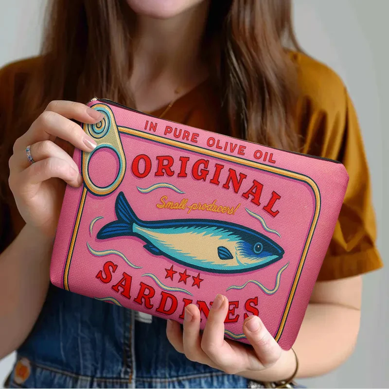 

Makeup Bag Designed like a Sardine Can Featuring a Stylish Zip Closure That Is Lightweight and Perfect for Both Travel