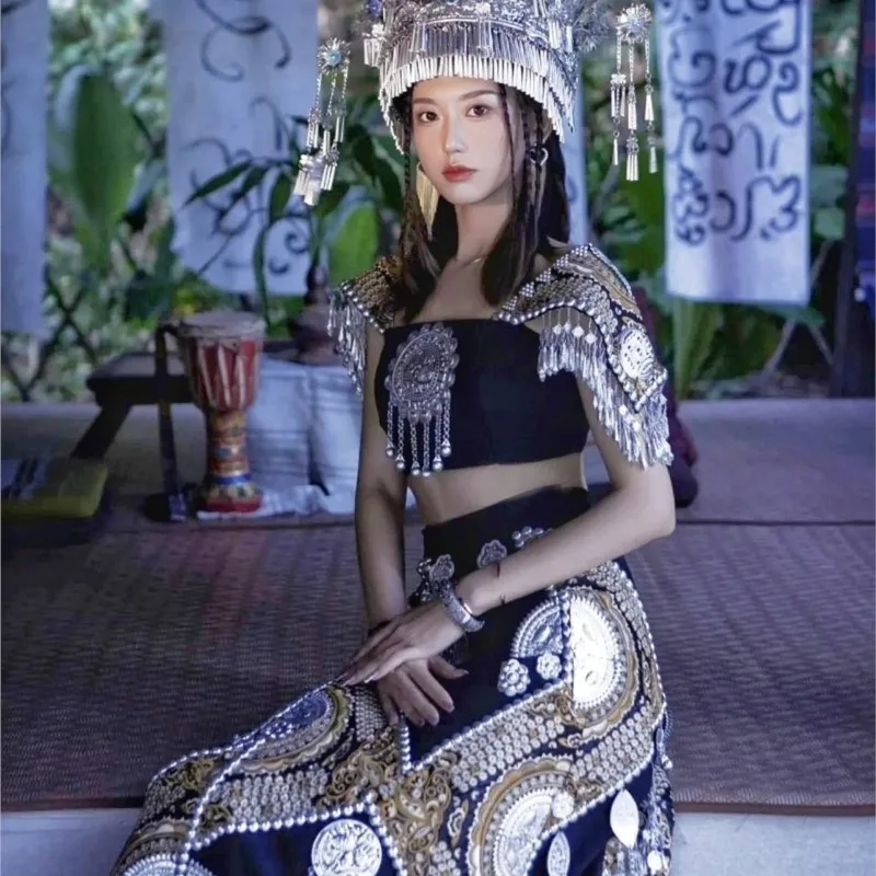 

A female ethnic style travel photography dress black heavy embroidery sequin strapless top long