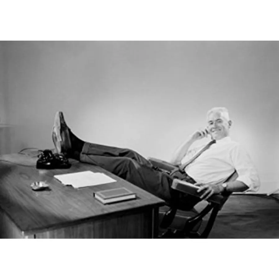 

Senior businessman sitting behind desk with feet up Poster Print 24 x 36