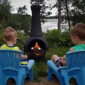 kids roasting marshmallows blue rooster chiminea outdoor fireplace fire pit