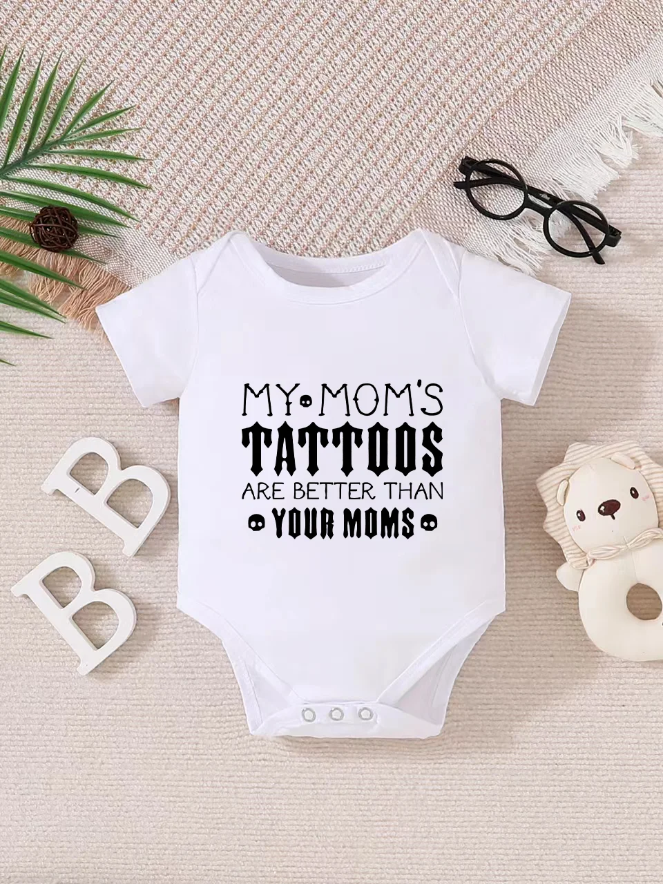 Playful letter-printed baby short-sleeve triangle bodysuit. Button closure for easy dressing