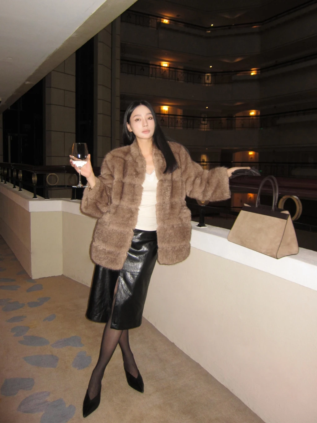 A slim and eco-friendly fur coat made of faux mink with 9-quarter sleeves