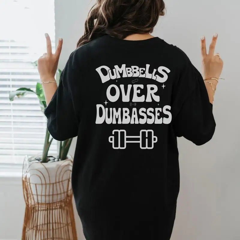 

"Dumbbells Over Dumbasses T-Shirt for Women | Funny Gym Quote Graphic Tee | Vintage Washed Workout Motivation Gift"