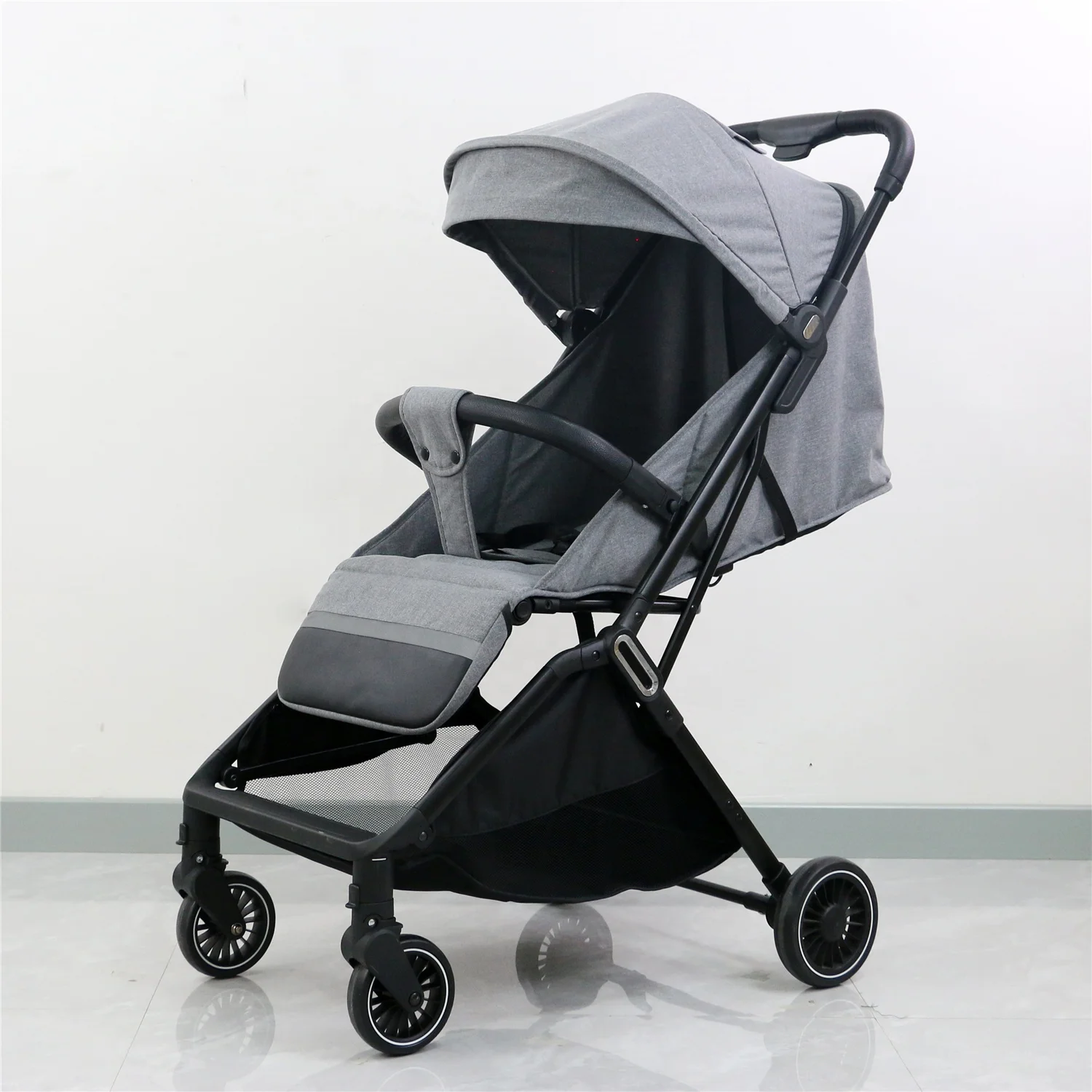 Auto-folding portable tri-fold PU leather handle and bumper travel stroller