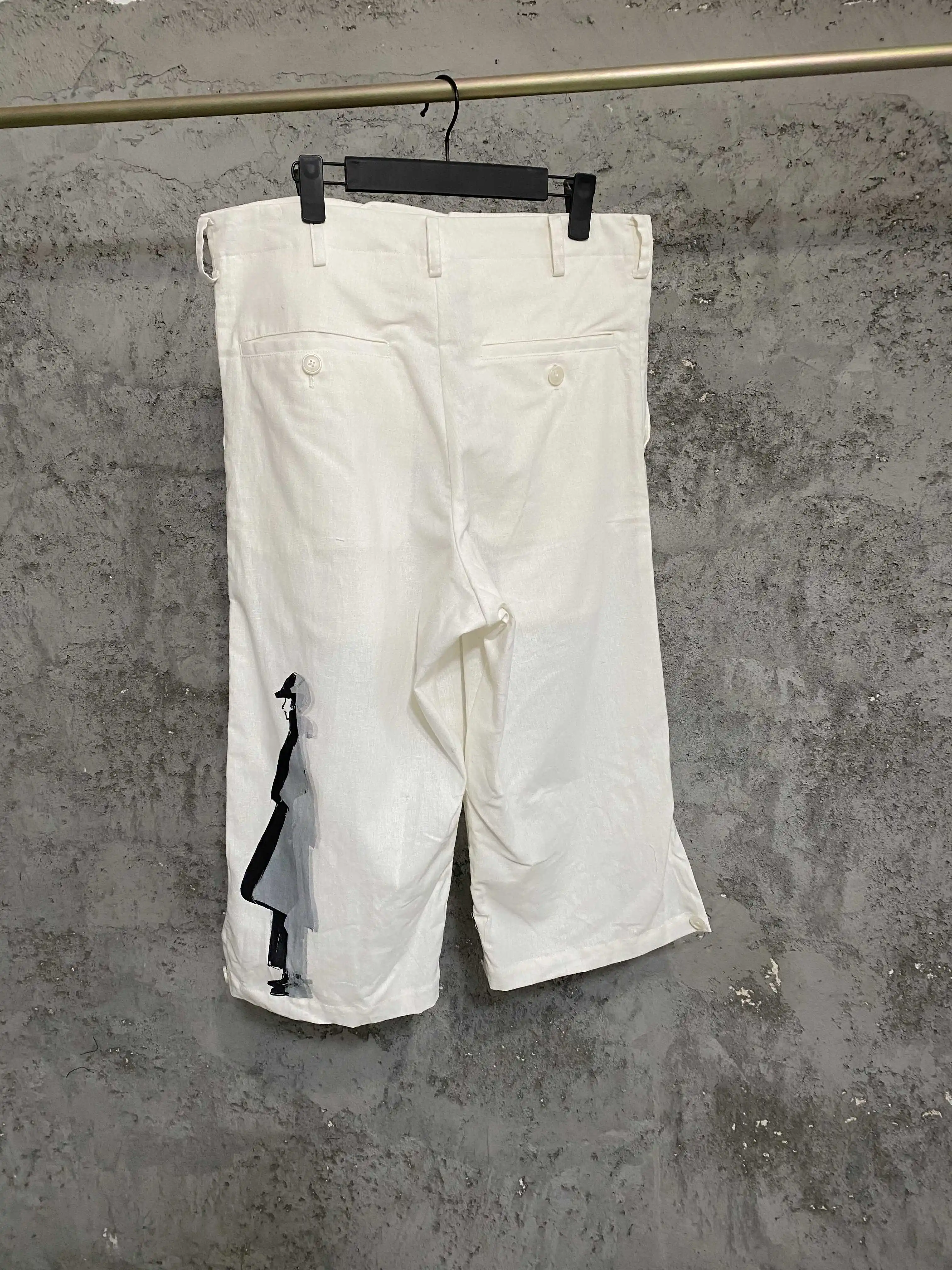 TOP-YAMAMOTO asymmetrical printed white capron pants and black printed pattern straight-leg casual pants for men